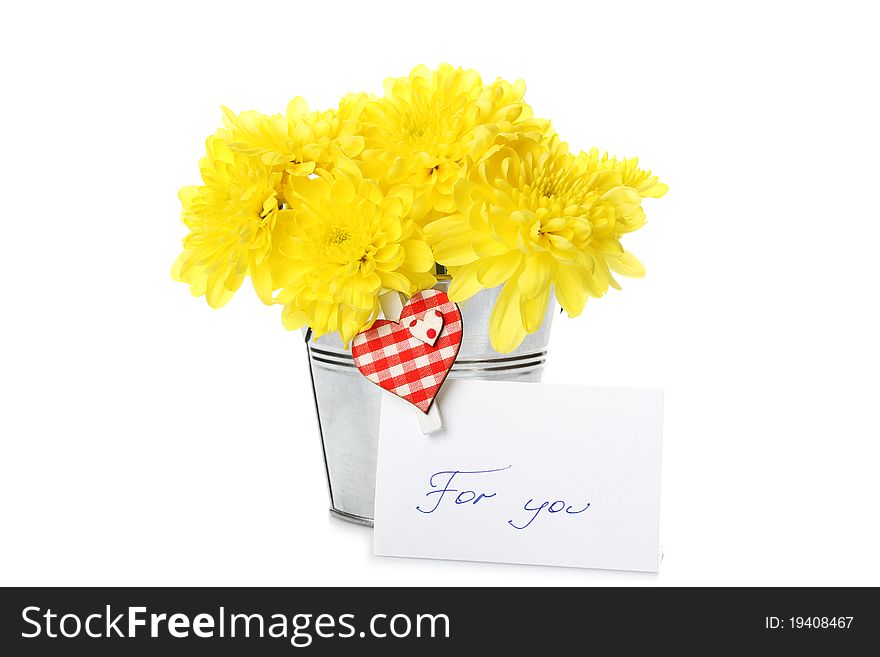 Yellow chrysanthemums in a bucket with chrysanthemums next card with the text for you and a pin with a red heart. Isolated. Yellow chrysanthemums in a bucket with chrysanthemums next card with the text for you and a pin with a red heart. Isolated