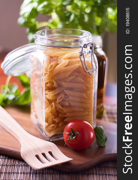 Dried penne pasta on the kitchen table