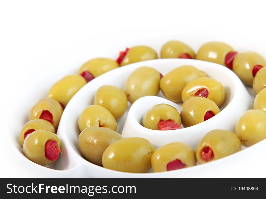 Green olives with paprika on white background