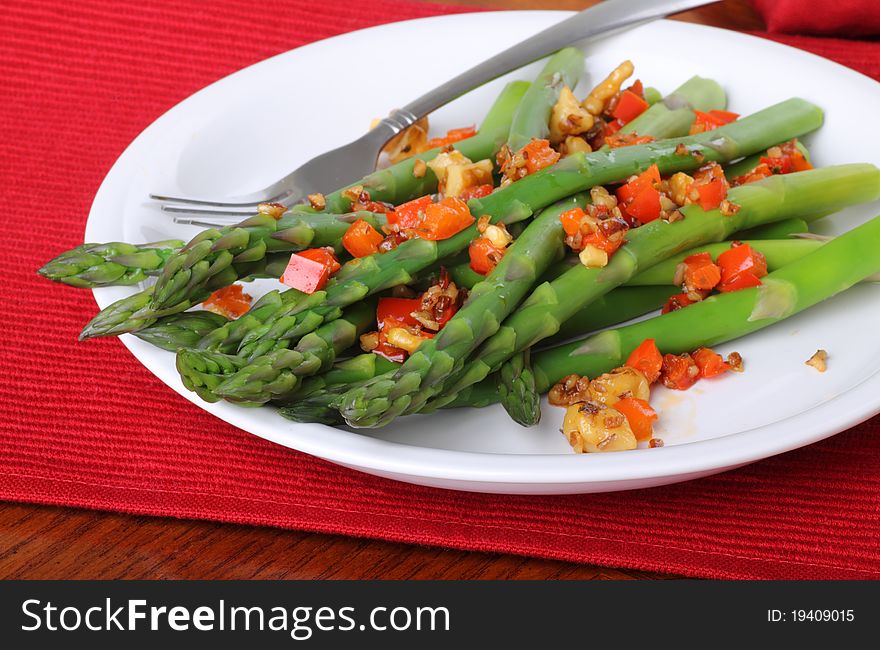 Asparagus with red peppers on a plate. Asparagus with red peppers on a plate