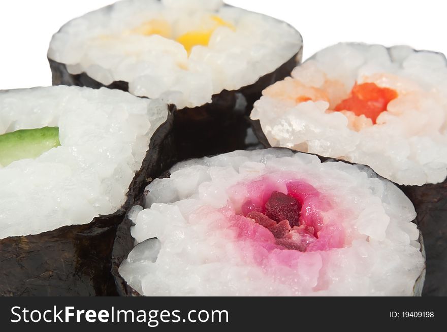 Close up capturing the tops of four fresh Maki Rolls with white background