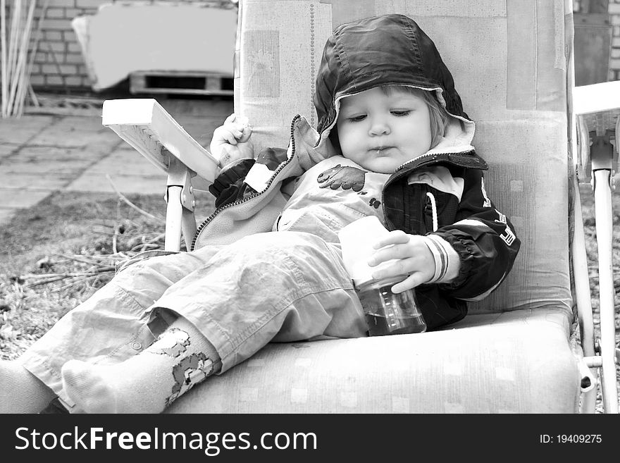 Baby girl eating outdoors. Black and White image of baby. Baby girl eating outdoors. Black and White image of baby.