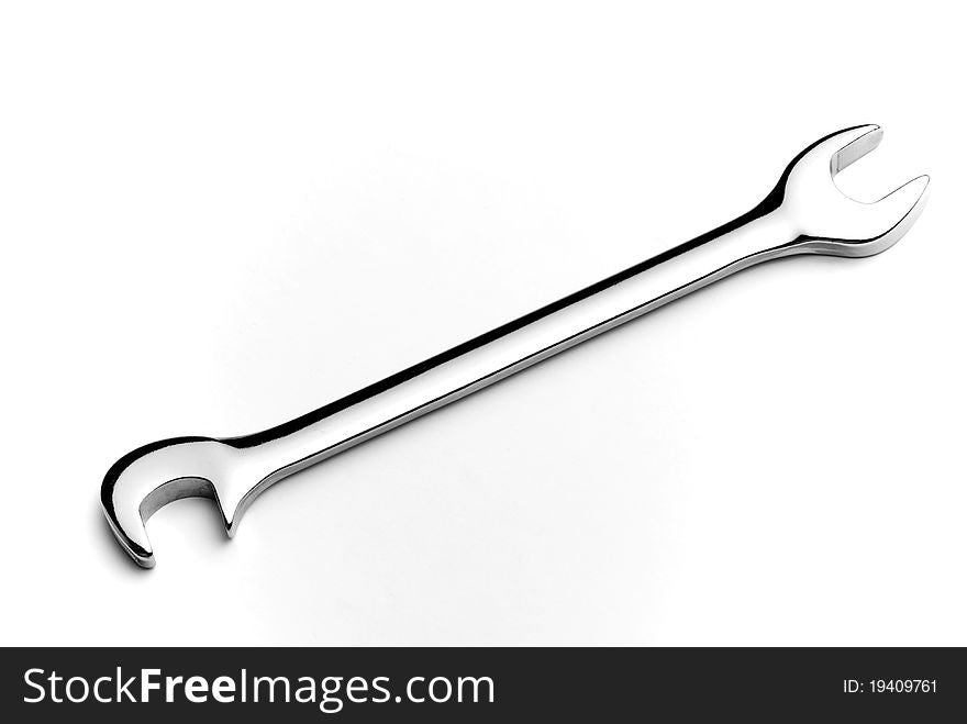 Close-up of chrome wrench on white background