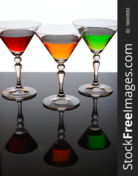 Three glasses of cocktail isolated on white