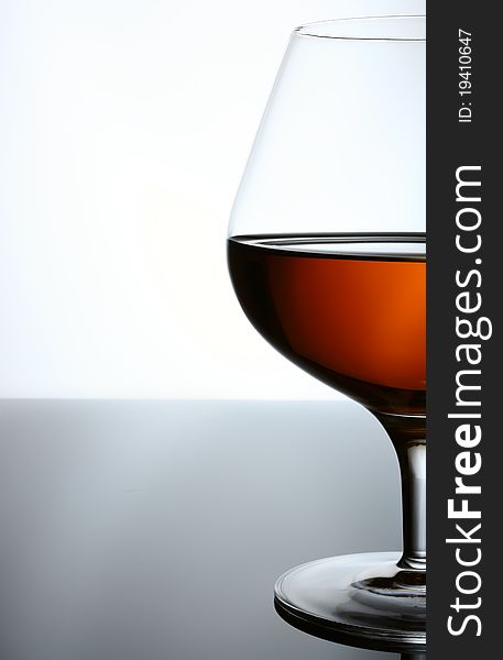 Cognac, whisky, rum, wine glass. Blue toned background