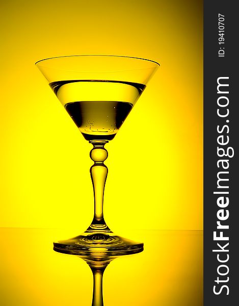 Glass with alcohol on gradient background
