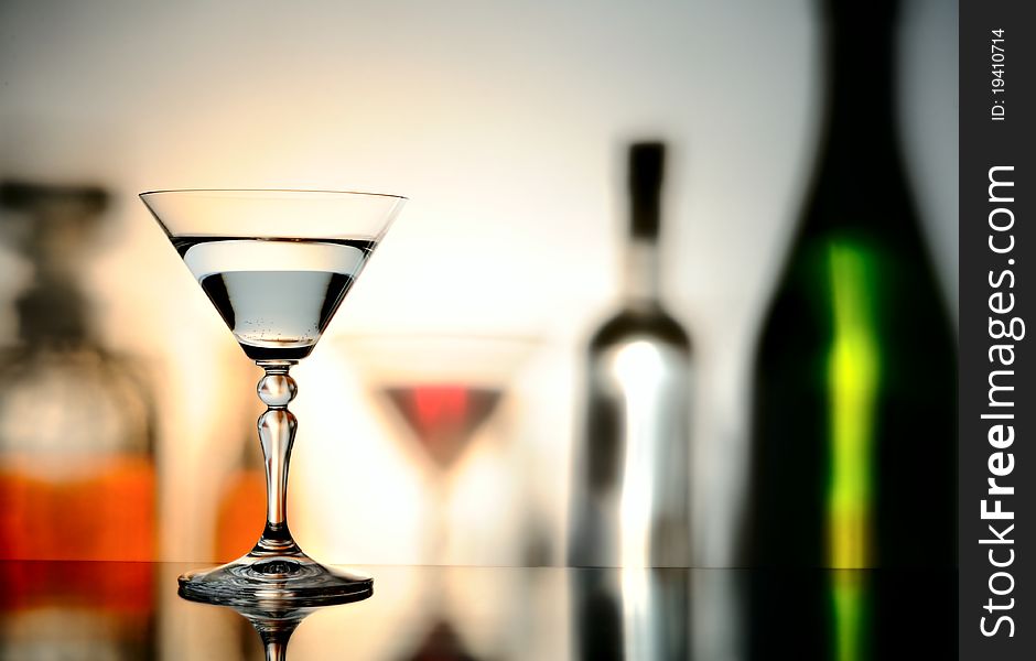 Glass on a background with the shadows of bottles. Glass on a background with the shadows of bottles