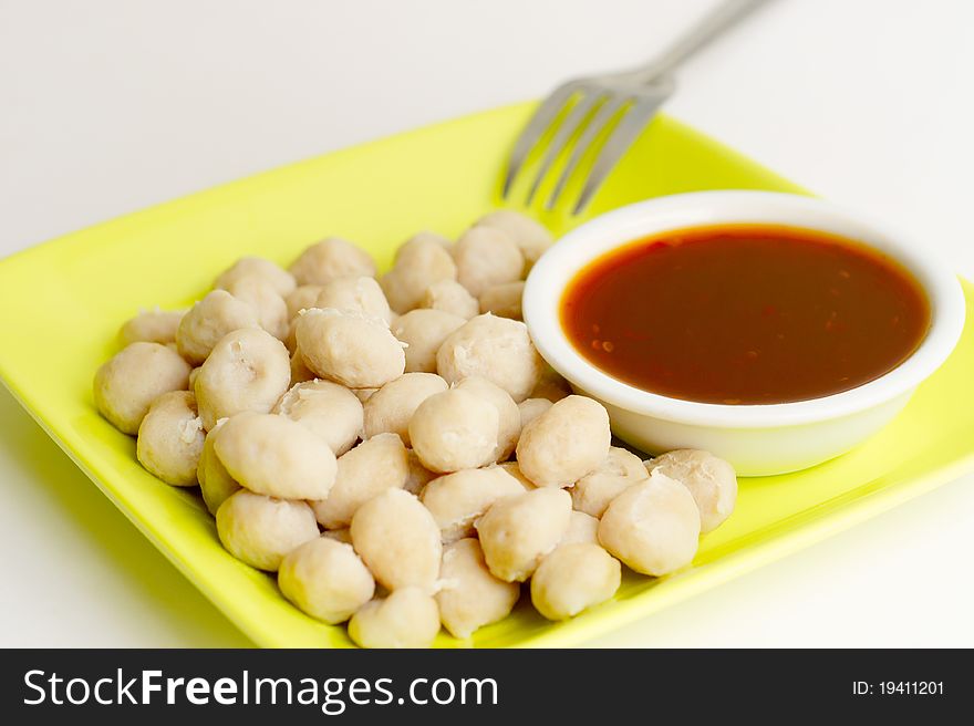 Meatballs on the green dish and spicy Thai style sauce