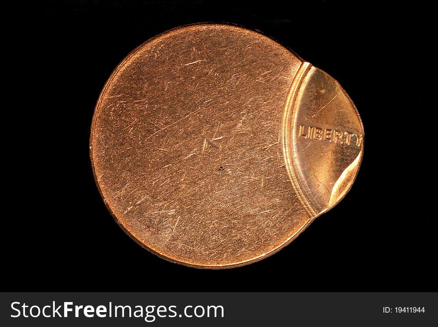 Penny round struck off-center on a black background. Penny round struck off-center on a black background.