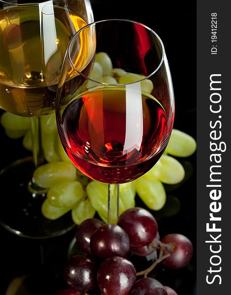 Red and white wine in glasses with grape. Top view