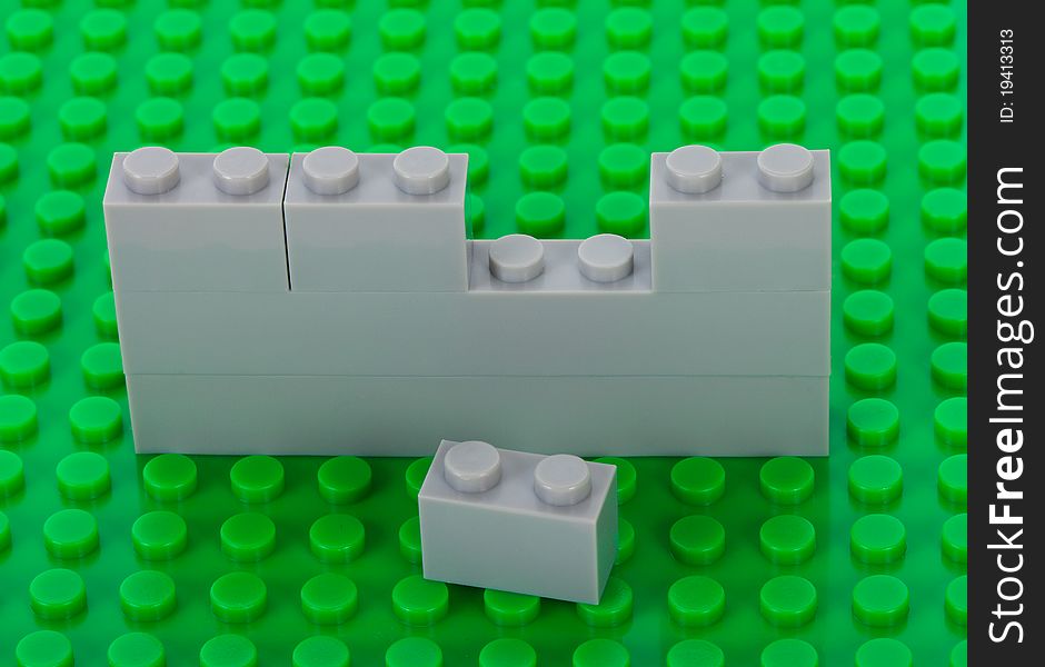 Plastic construction background with gray bricks