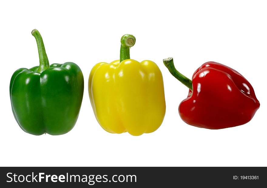 Three peppers, red, yellow, green, white background.