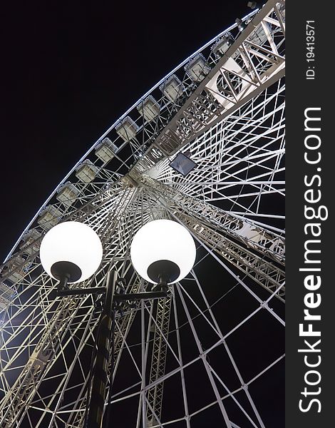 A giant ferris wheel, took from bottom-up, by night, with black background. A giant ferris wheel, took from bottom-up, by night, with black background