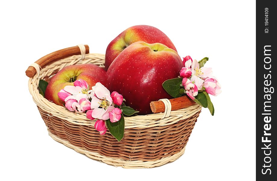 Red apples with flowers in a basket. Red apples with flowers in a basket