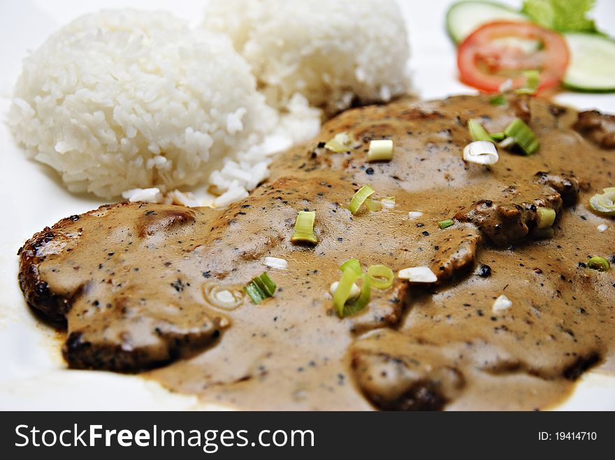 Beef steak with rice, onions and cucumber. Beef steak with rice, onions and cucumber