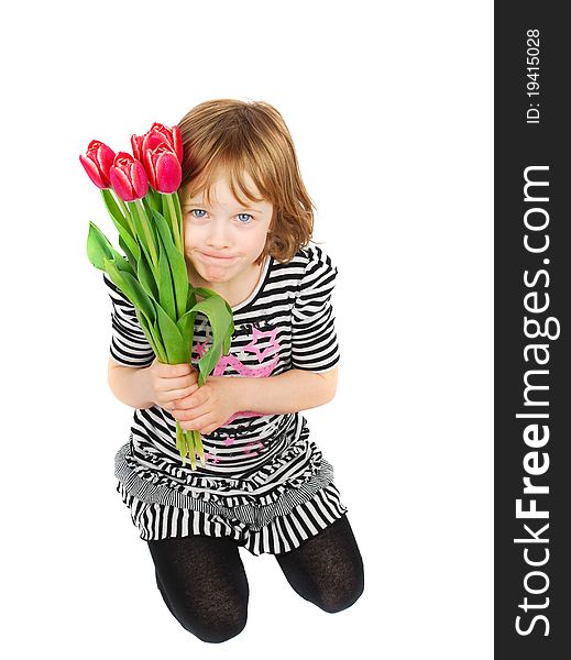 Young blond girl sitting down and holding a bouquet of pink tulips on a white background. Young blond girl sitting down and holding a bouquet of pink tulips on a white background