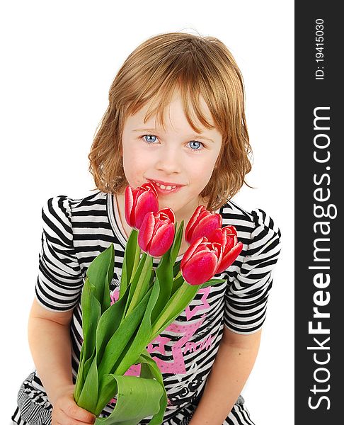 Young blond girl  sitting down and holding a bouquet of pink tulips on a white background. Young blond girl  sitting down and holding a bouquet of pink tulips on a white background