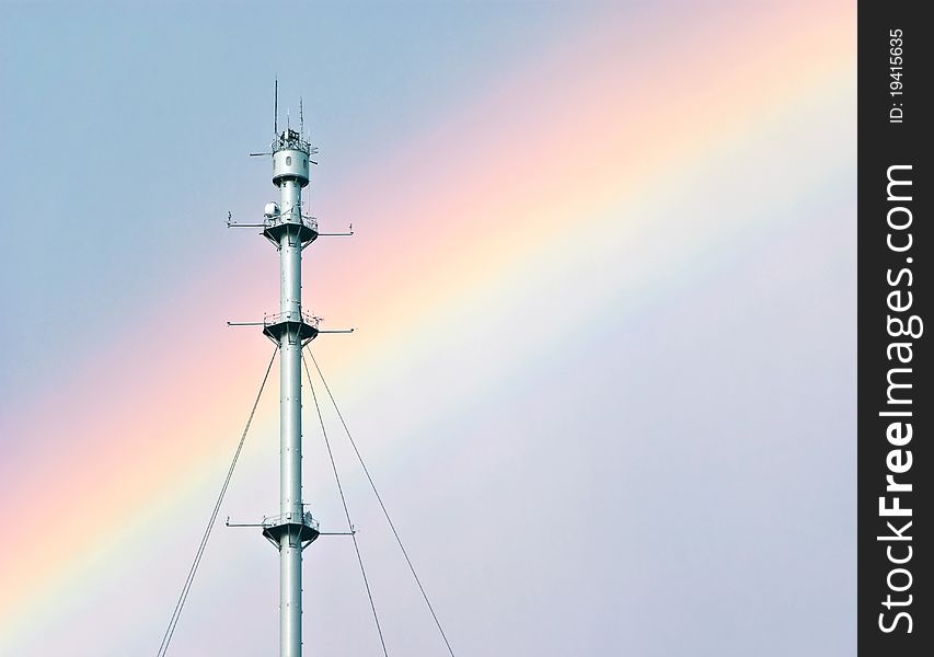 Radio mast against a rainbow after a thunder storm. Radio mast against a rainbow after a thunder storm