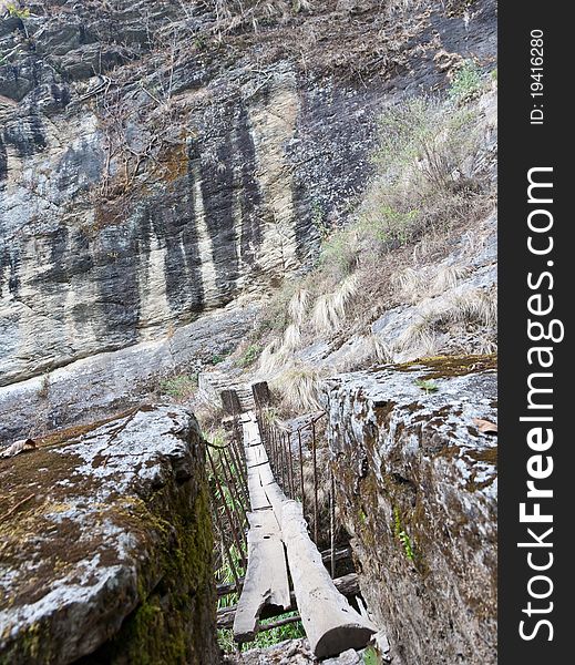 Suspension bridge covered with timber planks in the Langtang National Park, Nepal. Suspension bridge covered with timber planks in the Langtang National Park, Nepal.