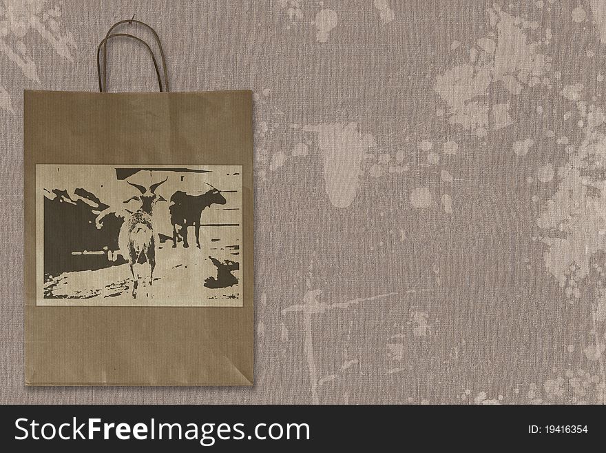 Paper bag hanging on spotted linen structure. Label with self-created design. Paper bag hanging on spotted linen structure. Label with self-created design