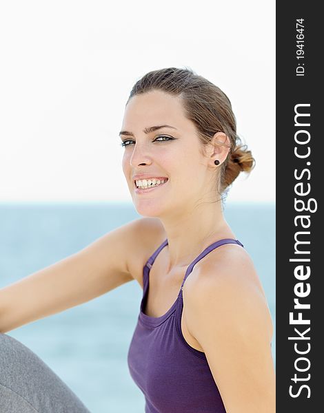 Portrait of young caucasian woman looking at camera near the sea. Horizontal shape, waist up, copy space. Portrait of young caucasian woman looking at camera near the sea. Horizontal shape, waist up, copy space