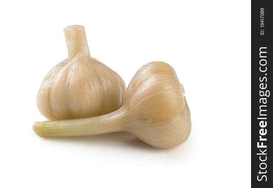 Two marinated head of garlics on the white background. Two marinated head of garlics on the white background