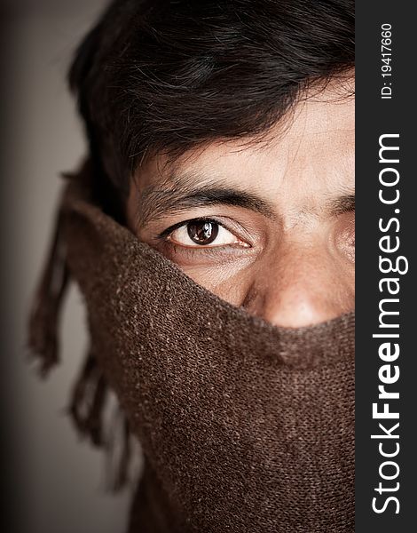 Close-up of an covered face by scarf of Indian farmer. Close-up of an covered face by scarf of Indian farmer