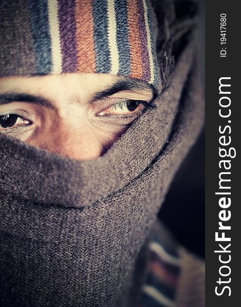 Close-up of an covered face by scarf of Indian farmer. Grains and textures are added for some old and grunge effect. Close-up of an covered face by scarf of Indian farmer. Grains and textures are added for some old and grunge effect.