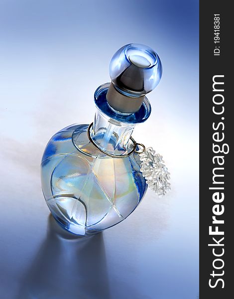 Blue perfume bottle on blue background