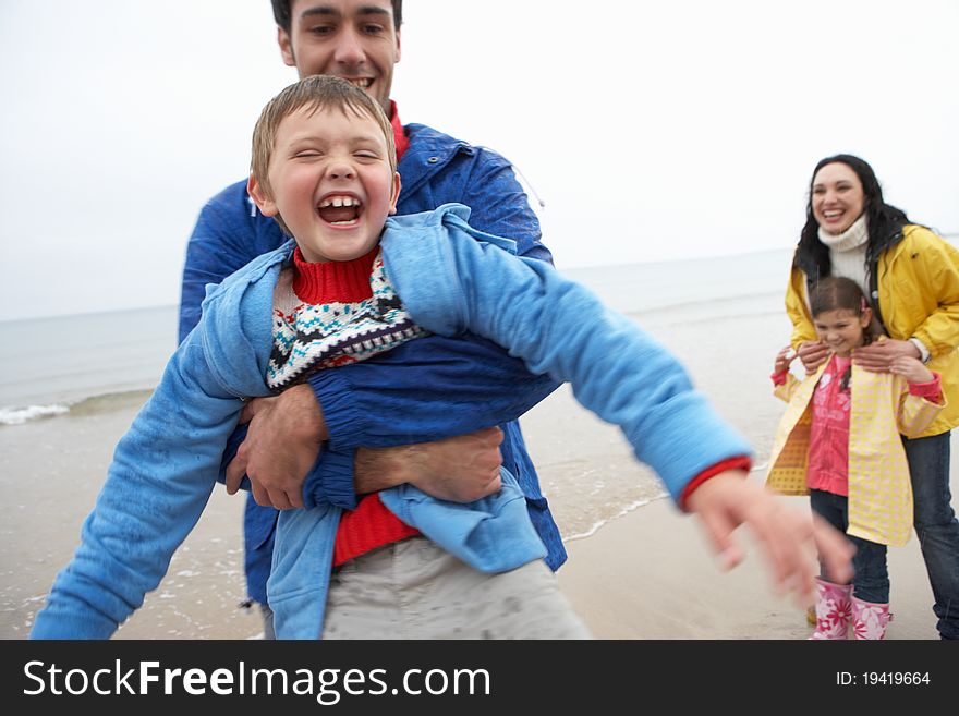 Happy family on beach smiling