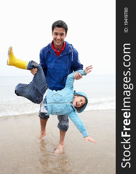 Happy father with son on beach playing