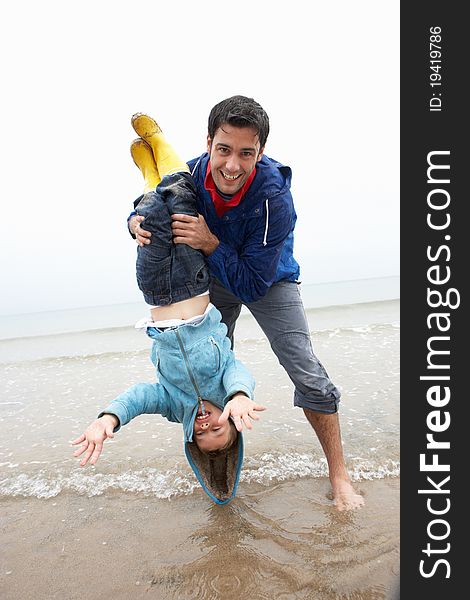 Happy Father With Son On Beach