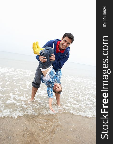 Happy father with son on beach