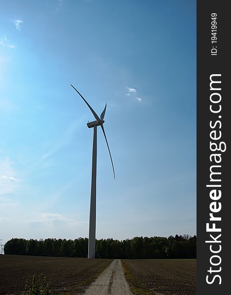 Wind turbines farm on sunset in summer