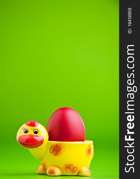 Colorful easter egg isolated over a green background