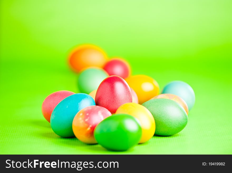 Colorful easter eggs isolated over a green background