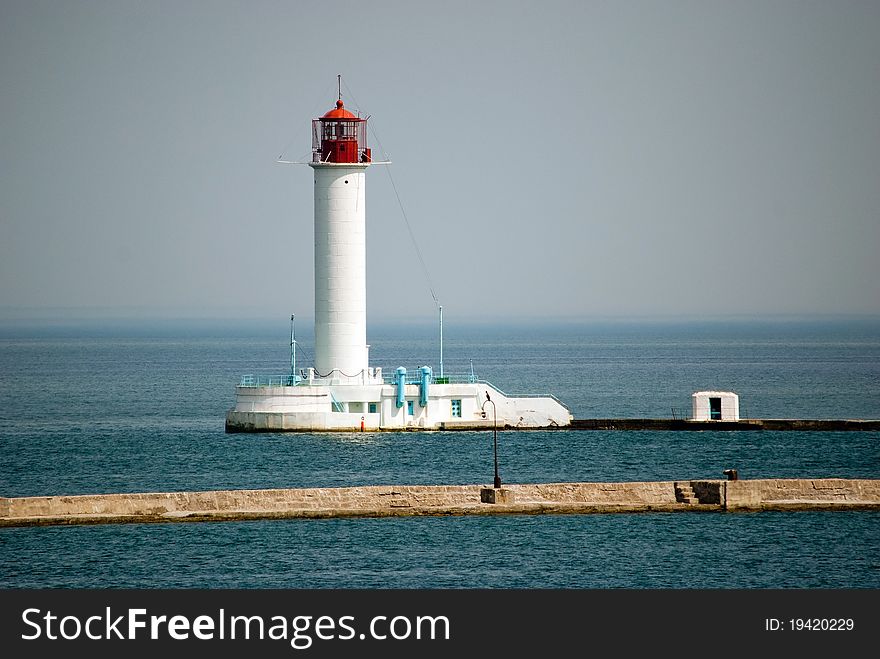 Lighthouse in the sea and the breakwater in front of it