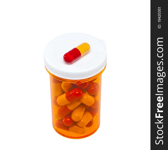 Medical pills container with yellow and red pills isolated on white. Medical pills container with yellow and red pills isolated on white.