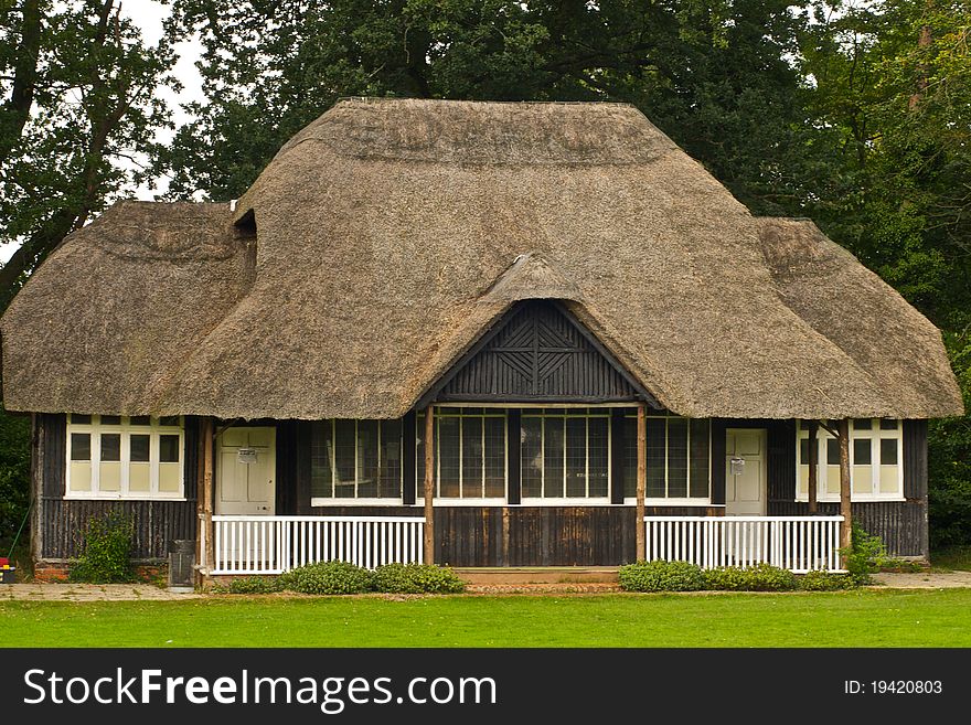 Village cricket pavilion with thatched roof and wooden construction