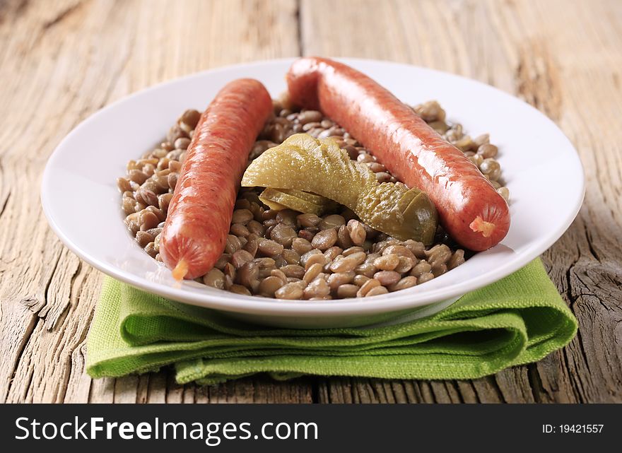 Cooked lentil with spicy sausages and pickles. Cooked lentil with spicy sausages and pickles