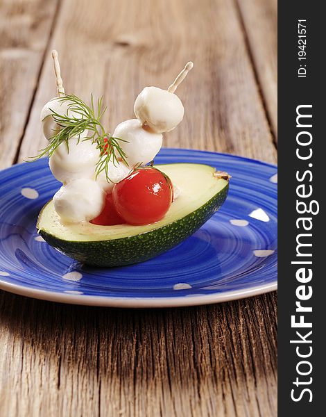 Vegetarian appetizer - Avocado, cherry tomatoes and mozzarella