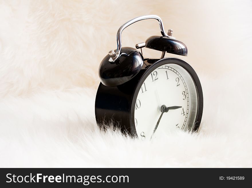 Vintage alarm clock on a warm rug