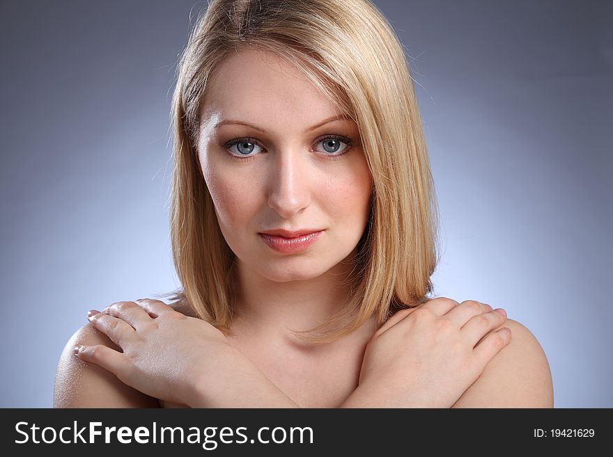 Hands on naked shoulders pose by beautiful young caucasian girl with bright blue eyes and blonde hair. Hands on naked shoulders pose by beautiful young caucasian girl with bright blue eyes and blonde hair.