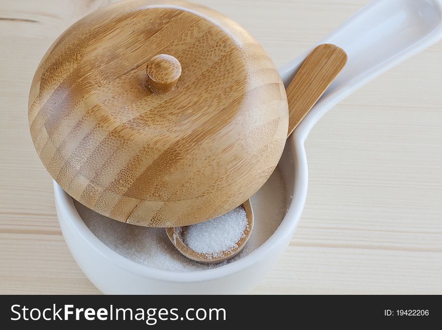 Sugar bowl with a wooden spoon and lid