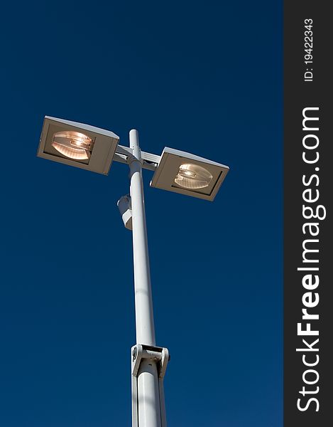 Streetlights are on during a sunny day, a waste of energy.