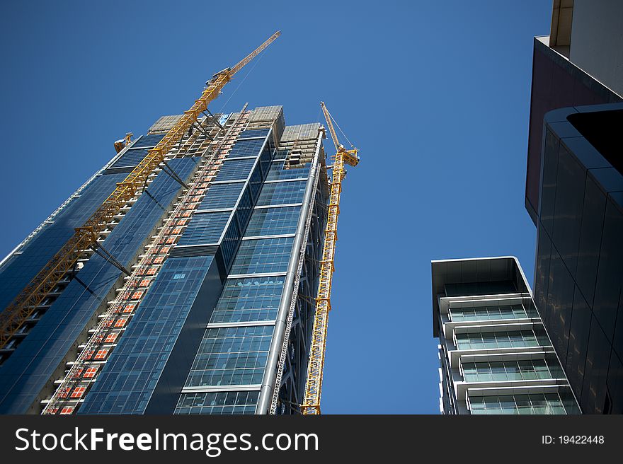 Upward view along a crane at a construction site in Perth Business District, Australia. Upward view along a crane at a construction site in Perth Business District, Australia.