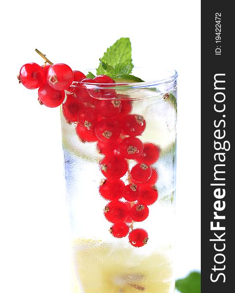 Glass of iced soda with lime and red currant