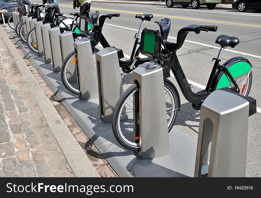 Rental bikes on rack in urban setting. Rental bikes on rack in urban setting