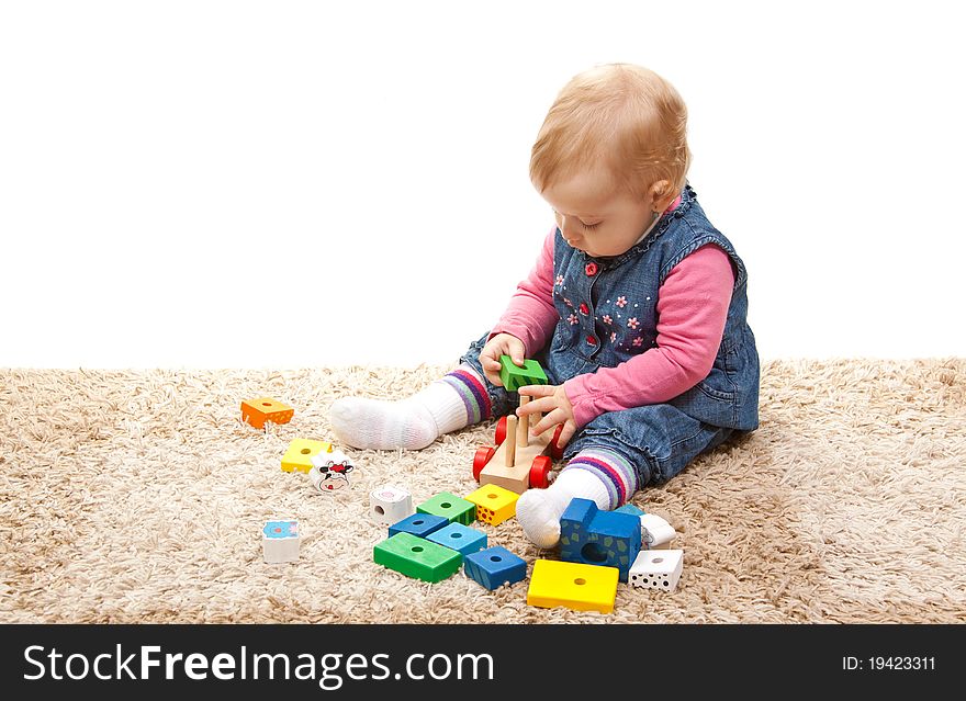 Little girl playing with wood train. Little girl playing with wood train