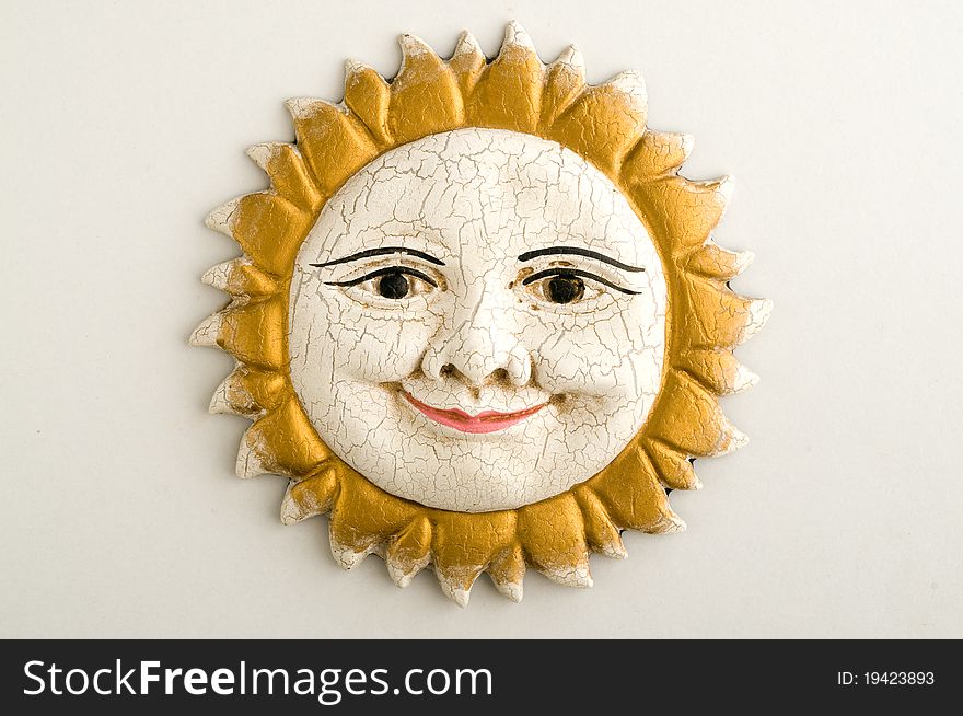 Handmade ornamental sun face with rays made by terracotta. Handmade ornamental sun face with rays made by terracotta
